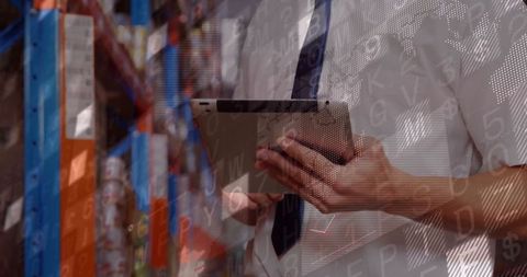 Warehouse supervisor using tablet for inventory management