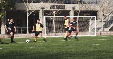 Male soccer players practicing teamwork on outdoor field