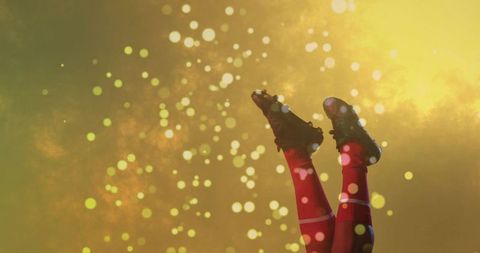 Dynamic Soccer Cleats and Red Socks Against a Sparkling Golden Background