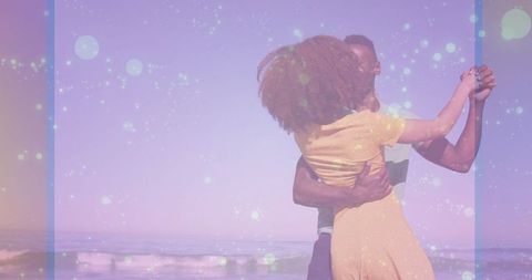 Romantic Couple Dancing on Tranquil Beach at Sunset