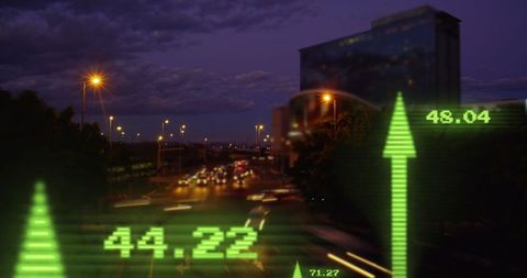 Financial growth arrows over blurred night cityscape