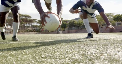 Dynamic Dive Rugby Action on Green Field