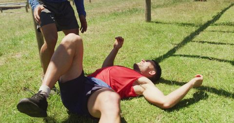 Fitness Trainer Aiding Injured Athlete on Obstacle Course - Download Free Stock Images Pikwizard.com