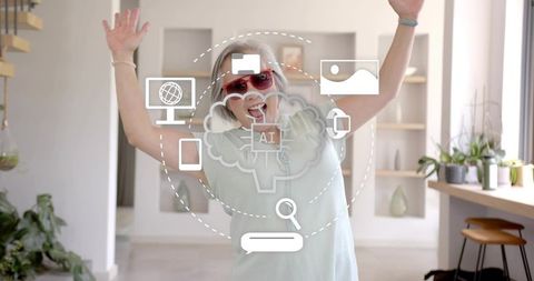 Mature woman celebrating ai technology at home wearing red sunglasses and wireless headphones