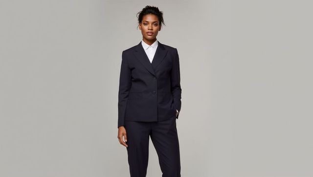 Confident african american woman wearing tailored navy suit and crisp white shirt