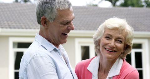 Senior Couple Enjoying Quality Time Outdoors with Smiles