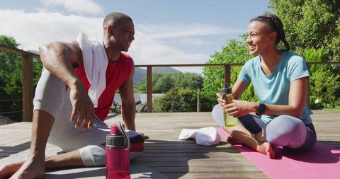 Couple Relaxing After Outdoor Workout on Sunny Terrace