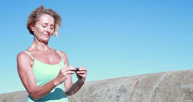 Active Mature Woman Using MP3 Player during Outdoor Workout - Download Free Stock Images Pikwizard.com