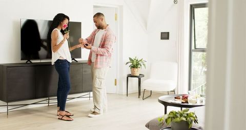 Romantic home engagement surprise with young couple