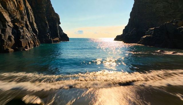 Turquoise sea glittering between towering rocky cliffs, foamy waves lapping shore