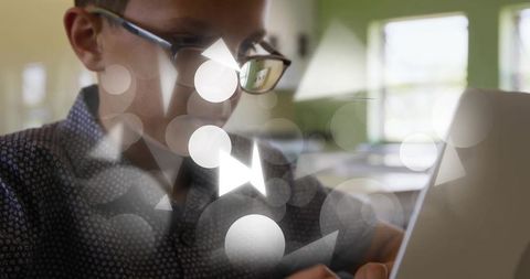 Focused student using tablet in classroom with digital overlays and bokeh light effects