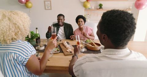 Diverse Friends Toasting at Home Brunch Gathering