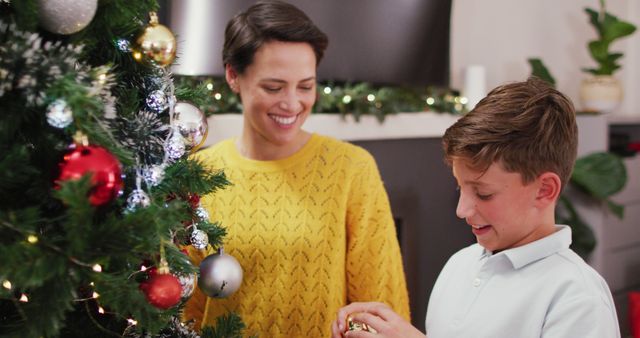 Mother and Son Decorating Christmas Tree Together - Download Free Stock Photos Pikwizard.com