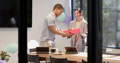 Colleagues celebrating birthday in modern office