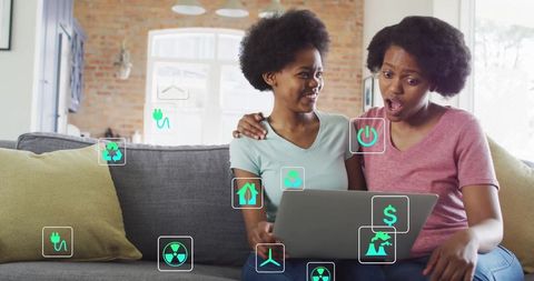 Mother and daughter embracing renewable energy with eco-friendly icons