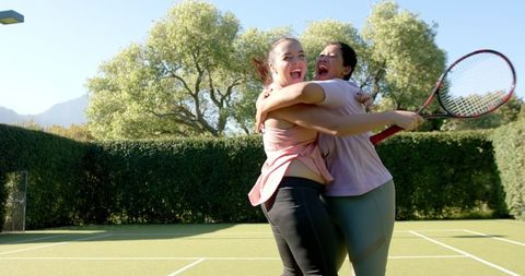 Joyful Tennis Victory Celebration Among Friends Outdoors