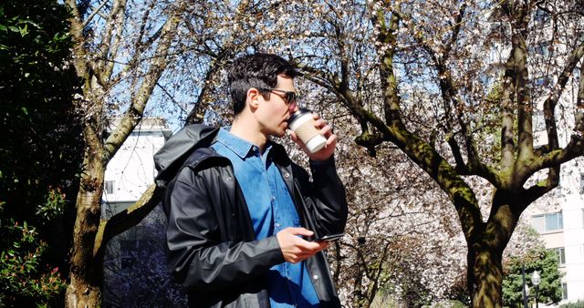 Man Drinking Coffee in Urban Park on Sunny Day - Download Free Stock Images Pikwizard.com