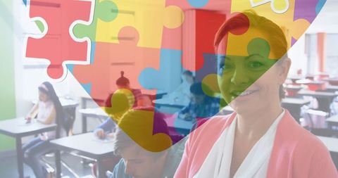 Female teacher smiling in classroom with puzzle heart overlay