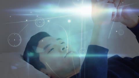 Technology Concept with Man Using Smartphone in Bed