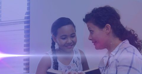 Mother and daughter bonding over storytime with magical light trails