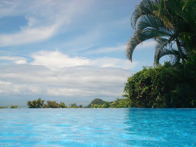Serene Tropical Pool with Scenic Sky - Download Free Stock Photos Pikwizard.com
