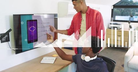 Young professionals collaborating and analyzing interactive charts on office display