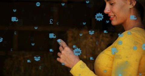 Woman browsing mobile shopping with holographic sale icons over rustic barn backdrop