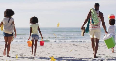 Family Enjoying Relaxing Walk on Sunny Beach Day, Carrying Beach Gear