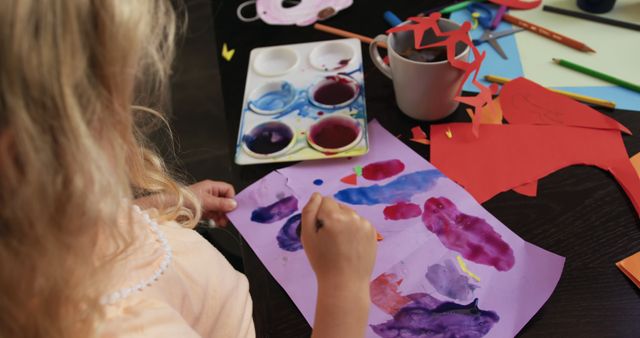 Young Girl Engaging in Arts and Crafts with Watercolors and Paper - Download Free Stock Images Pikwizard.com