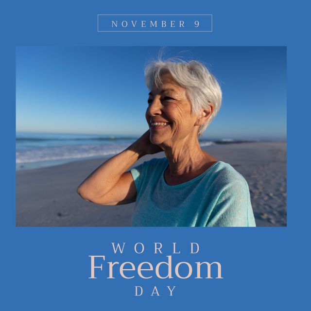 Image of world freedom day over happy senior biracial woman on beach. Freedom, holidays, vacations and relax concept.