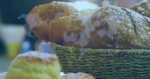 Artisanal sugared pastries in wicker basket with world map halftone overlay, warm bokeh