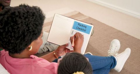 Mother and Daughter Planning Family Event Together at Home