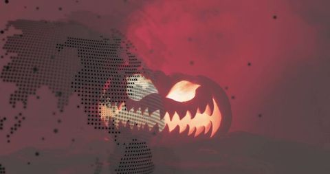 Glowing jack-o'-lantern with halftone globe overlay, smoky cinematic halloween concept