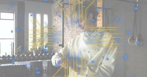 Woman checking smartwatch in industrial gym with ar fitness overlay and dumbbells