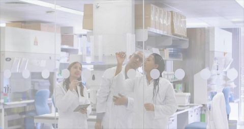 Team of researchers collaborating on project in modern laboratory