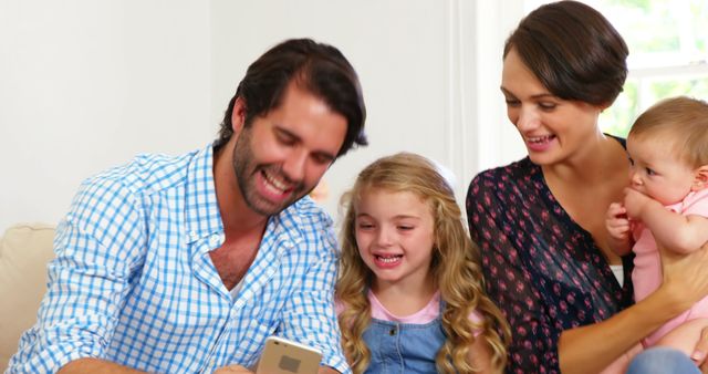 Happy Family Using Smartphone with Children Smiling at Home - Download Free Stock Images Pikwizard.com