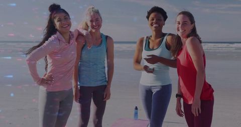 Diverse women laughing and posing after beach workout, outdoor fitness group lifestyle