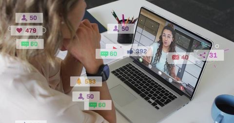 Woman watching remote presenter on laptop with social notifications overlay and workspace