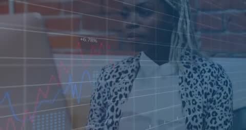 Business Analyst Examining Data on Laptop with Graphs Overlay