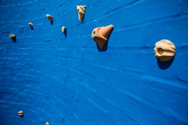 Blue Climbing Wall with Handholds at School - Download Free Stock Photos Pikwizard.com