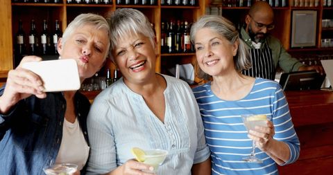 Joyful Friends Gathering for Selfie at Lively Bar - Download Free Stock Images Pikwizard.com