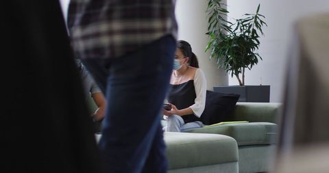 Colleagues Wearing Face Masks Discussing Work