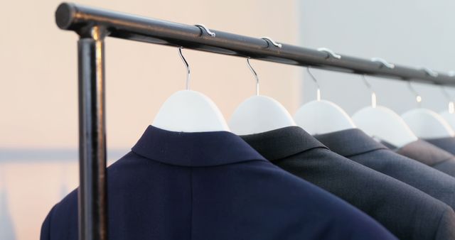 Row of Modern Suits on Hangers in Clothing Store - Download Free Stock Images Pikwizard.com