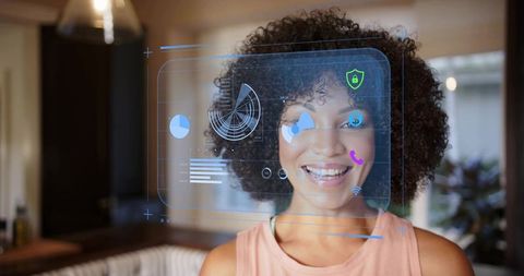 Smiling woman interacting with holographic AR interface in modern kitchen