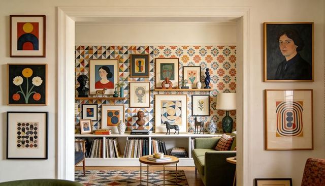 Showcasing eclectic gallery wall and built-in shelving in cozy midcentury sitting alcove