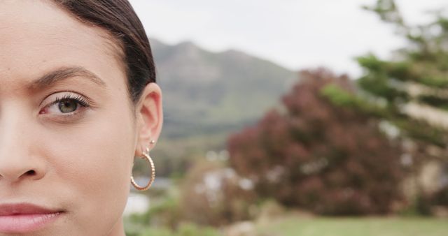 Close-Up Female with Earring, Nature Background - Download Free Stock Images Pikwizard.com