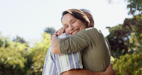 Diverse Couple Embracing in Sunlit Park