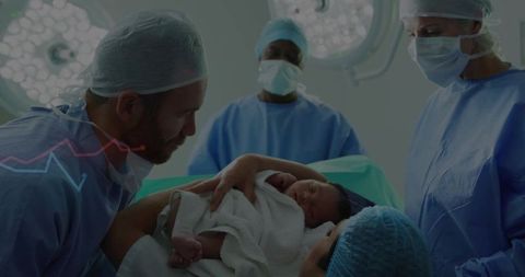 Father embracing newborn in hospital delivery room