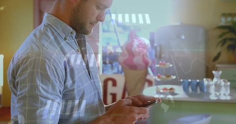 Man using smartphone viewing augmented reality analytics and charts at cafe dessert counter