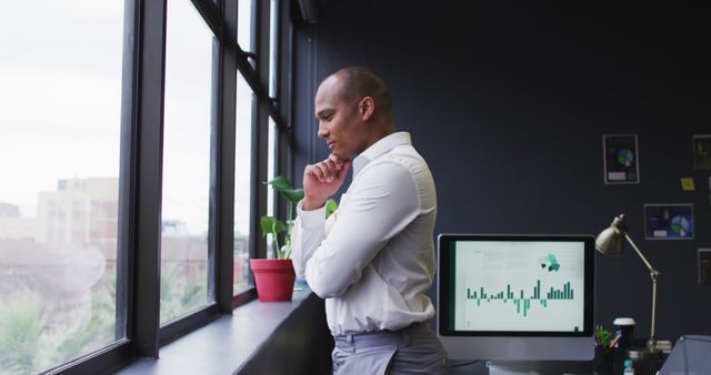 Thoughtful Businessman Looking Through Office Window - Download Free Stock Images Pikwizard.com